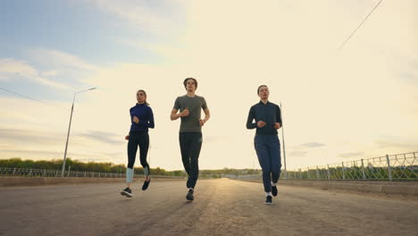 Jogger-Laufen-Morgens-Im-Freien.-Drei-Junge-Menschen-Trainieren-Gemeinsam-Und-Bereiten-Sich-Auf-Den-Marathon-Vor